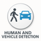 Circular 3D icon showing a pedestrian silhouette and a blue car, symbolizing human and vehicle detection for security cameras